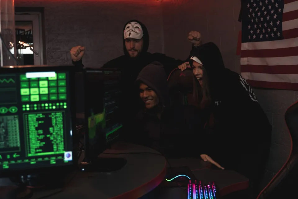 IT professionals reviewing security information on computers in an office.